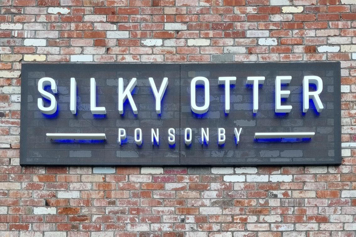 Silky Otter cinema sign on brick wall